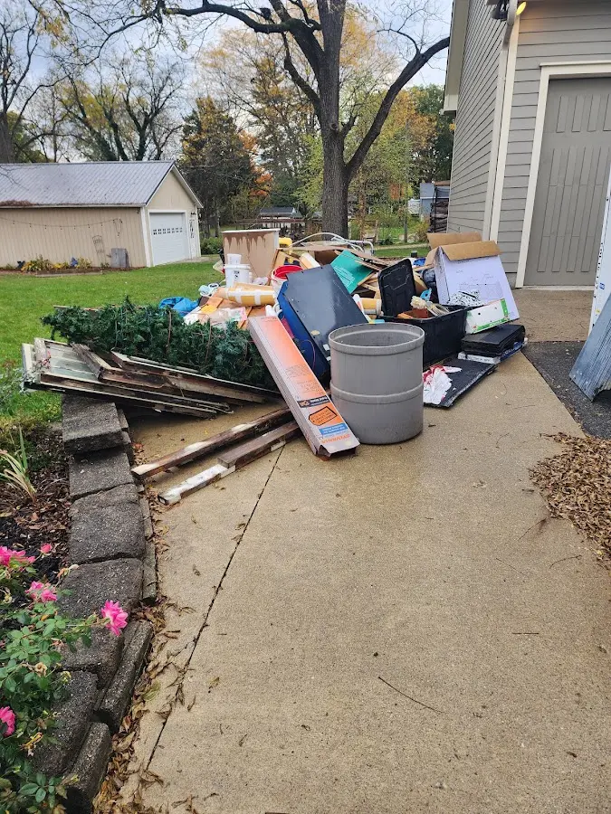 Dumpster being loaded with debris for 12 Yard Dumpster Rental in Mayfield